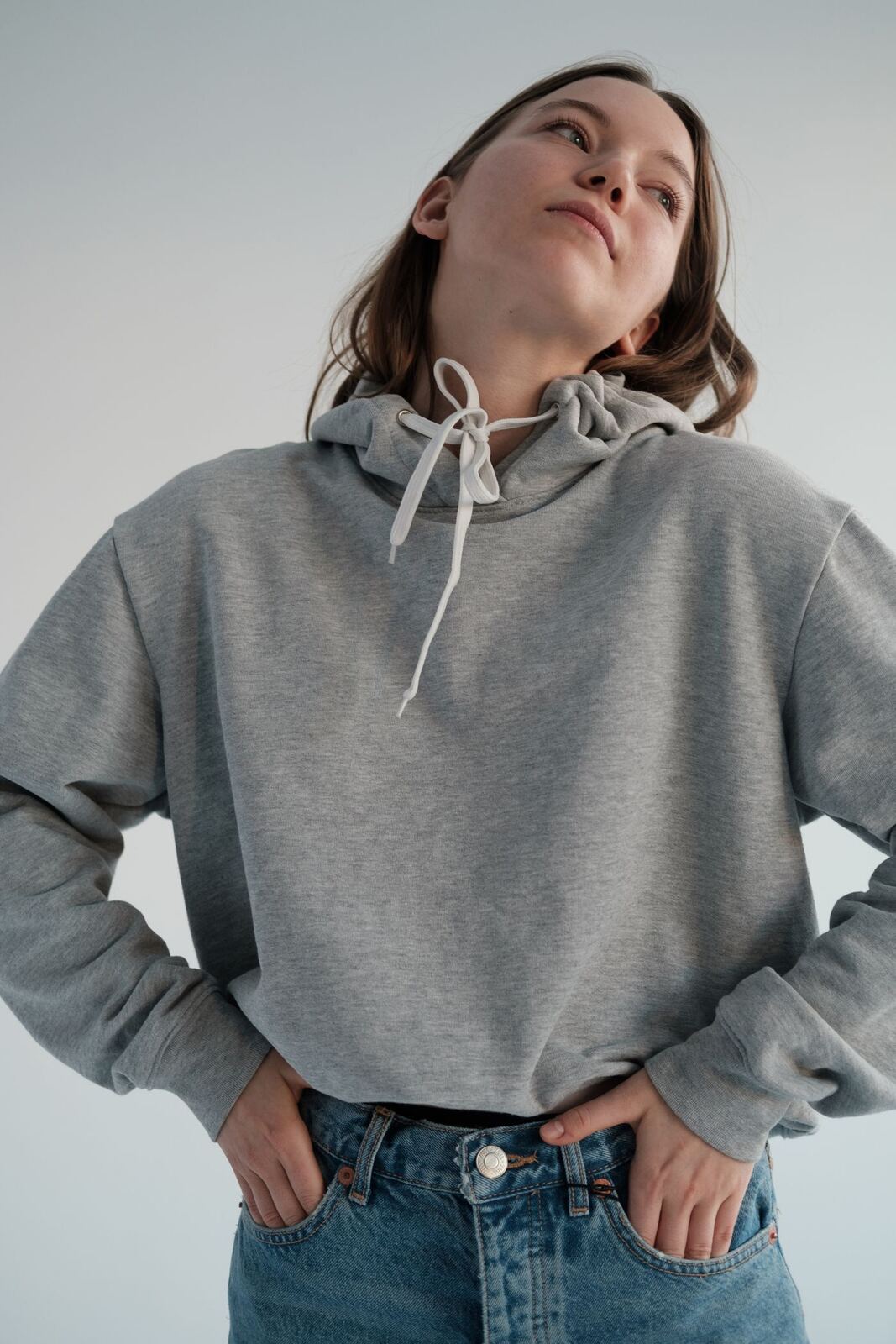 Model wearing a grey heavyweight hoodie with denim