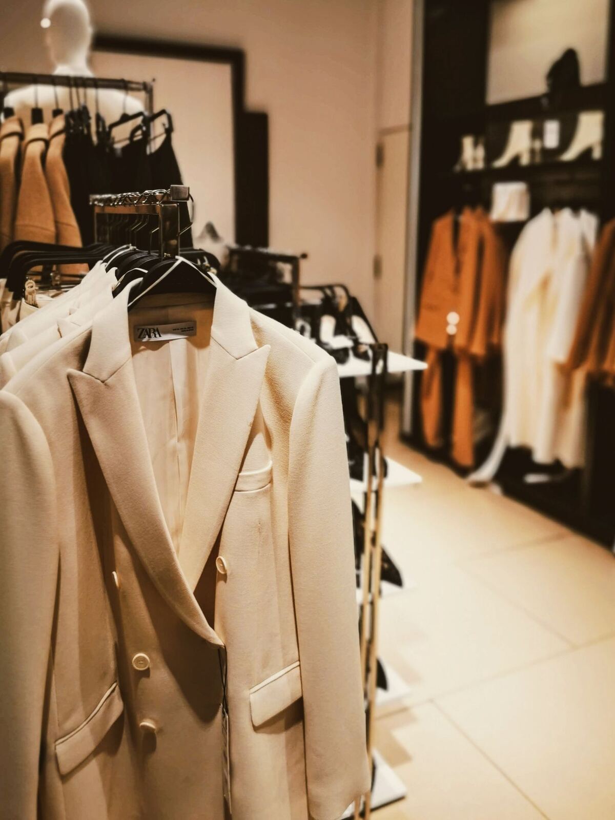 Neatly arranged neutral garments on a rack
