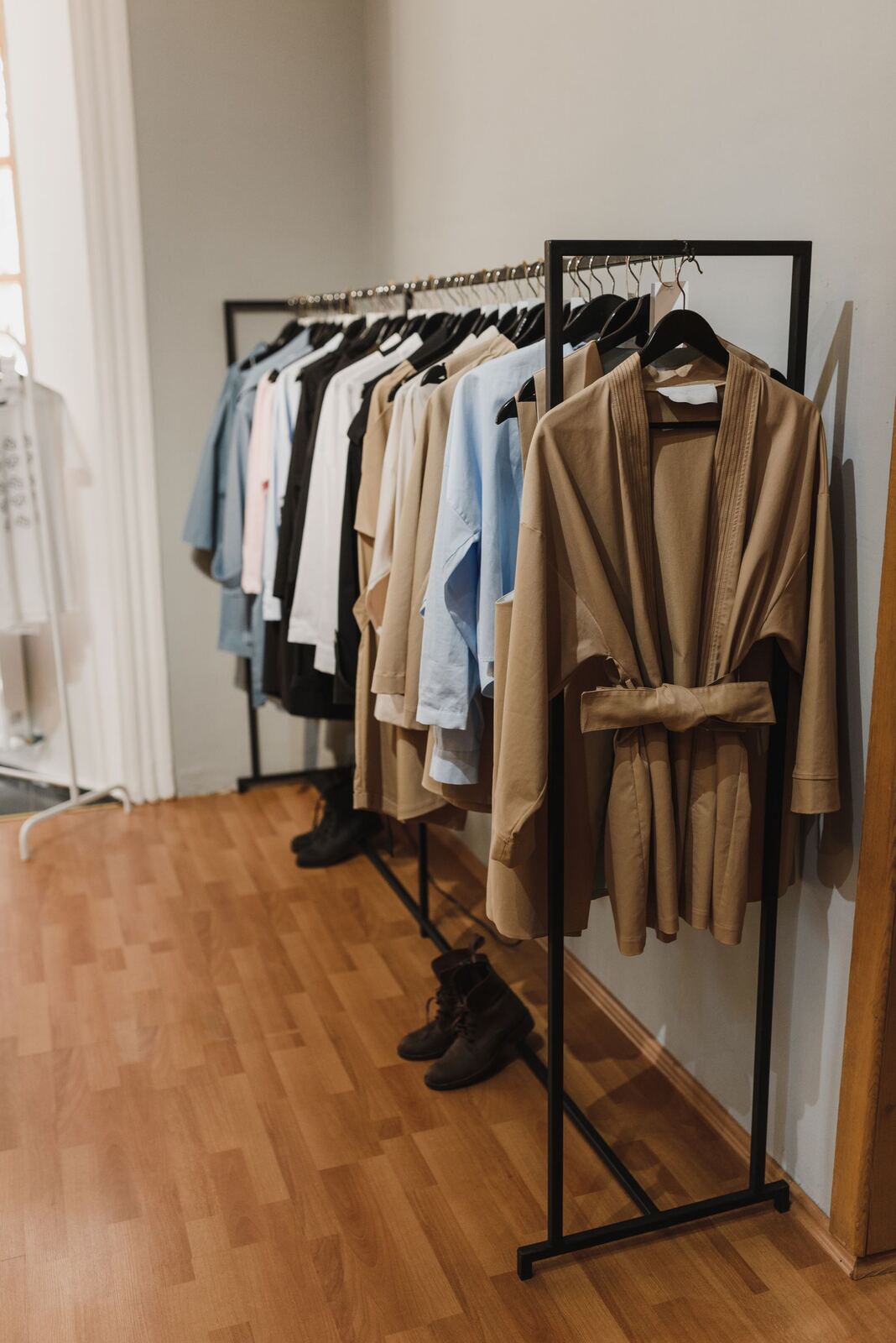 Rack of neutral-toned garments in a studio